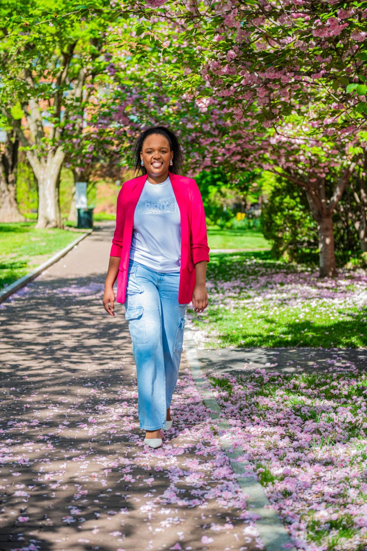 Kudzani (KK), founder of Identity Cove, walking through Philadelphia in spring.